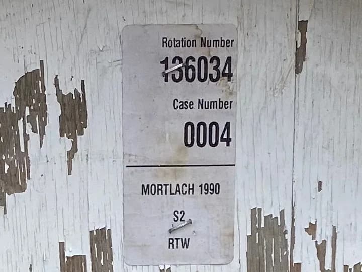 A warehouse rotation-number label on a Mortlach 1990 cask